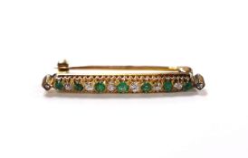 A yellow metal, seven stone emerald and eight stone diamond chip set bar brooch, 32mm, gross