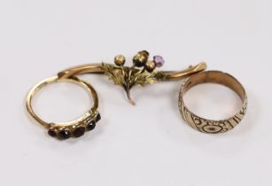 A 9ct and graduated five stone facetted garnet set ring, an engraved 9ct gold band and a 9ct gold