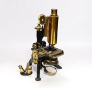 A Victorian monocular brass and black enamel microscope by W. Watson & Sons, High Holborn, in a