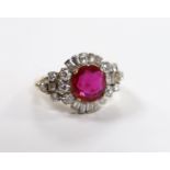 A yellow metal, singe stone round cut synthetic ruby and diamond set circular cluster dress ring,