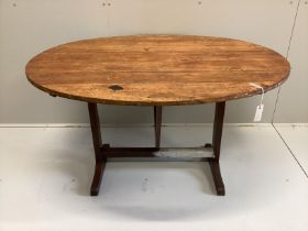 A 19th century French oval pine and fruitwood Vigneron, width 125cm, depth 101cm, height 72cm