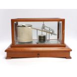 A modern 1980s barograph by Casella in a teak case with bevelled glass panels and incorporating a