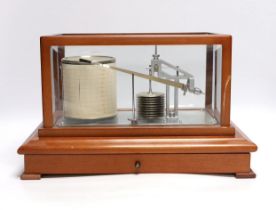 A modern 1980s barograph by Casella in a teak case with bevelled glass panels and incorporating a