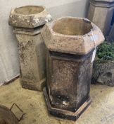 A pair of hexagonal terracotta chimney pots, larger height 71cm