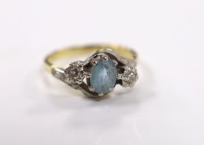A modern 18ct gold, aquamarine and illusion set diamond three stone crossover ring, size N, gross