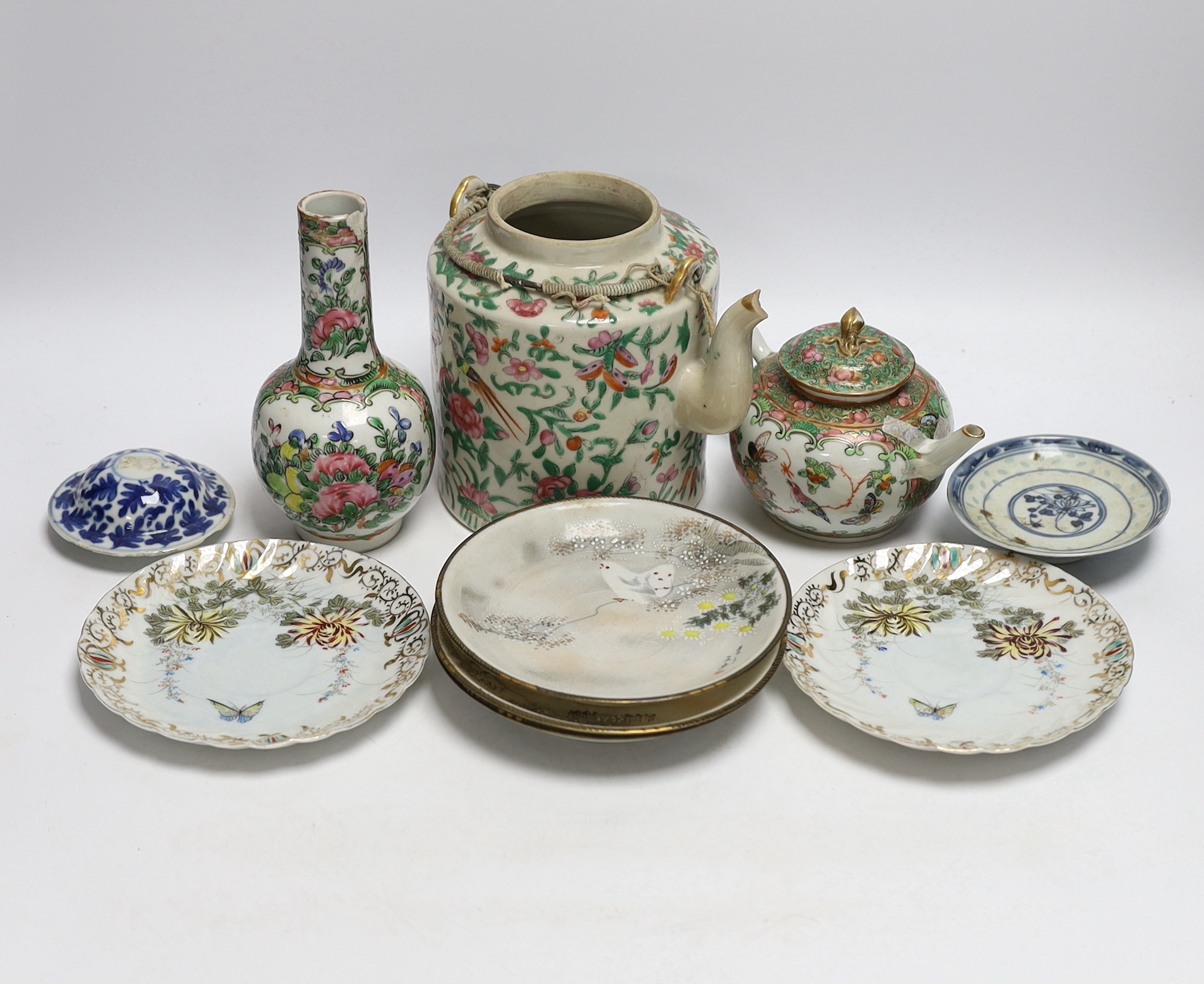A collection of Chinese and Japanese ceramics including two famille rose teapots, a vase, four
