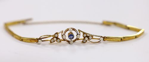 An Edwardian 15ct, sapphire and seed pearl cluster set expanding link bracelet, with safety chain,