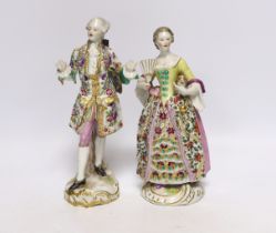 A pair of Continental porcelain figures wearing 18th century dress, largest 24cm high