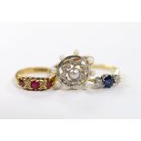 An 18ct, sapphire and diamond set three stone ring, a George V 18ct gold and three red stone set