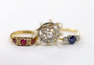 An 18ct, sapphire and diamond set three stone ring, a George V 18ct gold and three red stone set