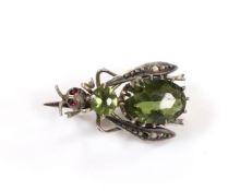 A late Victorian gilt white metal and green paste set bug brooch, 23mm.
