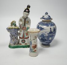 An 18th century Chinese enamelled porcelain figure of a lady standing by rockwork, a similar