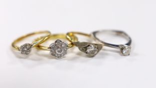 Three assorted 18ct and solitaire diamond rings and an 18ct gold and diamond set flower head ring,