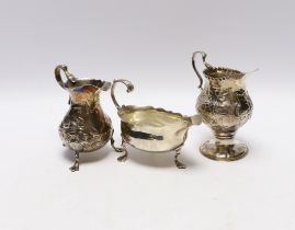 A late George II silver sauceboat with flying scroll handled, London, 1759 and two Georgian silver