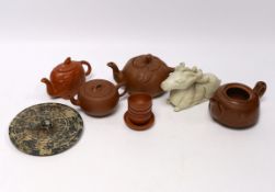 Eleven Chinese items including four Yixing pottery teapots, a stone disc, a jade horse and five