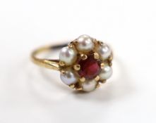 A 9ct gold, garnet and seed pearl cluster set flower head ring, size I, gross weight 2.4 grams.