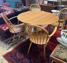 An Ercol oval elm drop leaf dining table, length 123cm extended, width 113cm, height 71cm and four