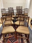 A harlequin set of twelve 19th century Lancashire ash elm and beech rush seat spindle back chairs