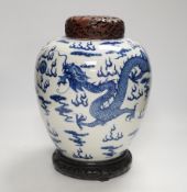 A large Chinese blue and white jar decorated with dragons chasing the flaming pearl together with