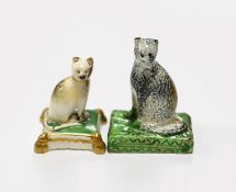 A rare Staffordshire pearlware model of a seated cat, c.1830, 5cm high and a Rockingham porcelain