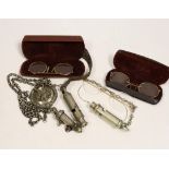 Three pairs of pince-nez and three police whistles