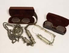 Three pairs of pince-nez and three police whistles