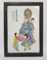 A framed Chinese porcelain plaque decorated with figures and calligraphy, overall 40cm x 29cm