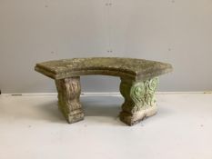 A weathered reconstituted stone curved garden bench, width 110cm, depth 48cm, height 45cm