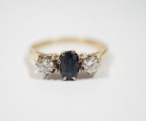 An 18ct, sapphire and diamond set three stone ring, size N, gross weight 2.8 grams.