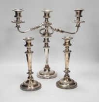 A Sheffield plate two branch, three light candelabra and a pair of candlesticks, candelabra 36cm