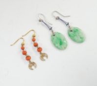 A pair of 9ct white metal and carved oval jade set drop earrings, jade 21mm and a pair of yellow