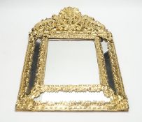 An 18th century-style embossed brass mirror, 58cm high