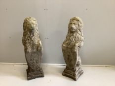A pair of weathered composition stone heraldic lion garden ornaments, height 80cm