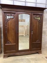 A late 19th century French Art Nouveau carved oak compactum wardrobe, width 205cm, depth 64cm,