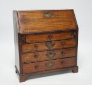 A George II miniature mahogany bureau with fitted interior and three drawers, 27cm high