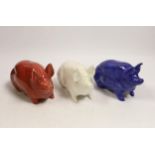 Three Wemyss ware pigs in cream, blue and pink glazes, 15cm