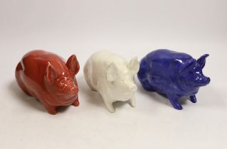 Three Wemyss ware pigs in cream, blue and pink glazes, 15cm