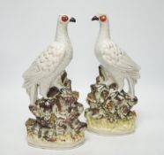 A pair of 19th century Staffordshire models of birds, each 32cm high