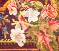 An early 20th century woven multi coloured plush floral piano or table cover