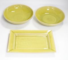 Two lime green crackle glazed bowls and a similar rectangular dish, by Jars of France, largest 30cm