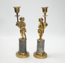 A pair of brass figural and candlesticks, 27cm high