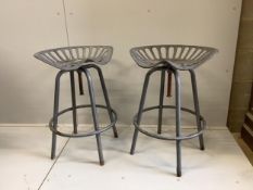 A pair of 'tractor seat' bar stools, width 50cm, height 68cm