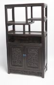 An early 20th century Chinese hongmu cabinet with carved cupboard doors, 61cm high
