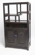 An early 20th century Chinese hongmu cabinet with carved cupboard doors, 61cm high