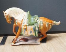 A large Chinese Tang-style pottery model of a tomb horse, 54cm long