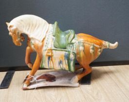 A large Chinese Tang-style pottery model of a tomb horse, 54cm long