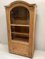 A 19th century East European glazed pine cabinet, width 95cm, depth 49cm, height 184cm