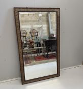 A Victorian style bevelled glass rectangular wall mirror with a moulded gesso oak leaf and acorn