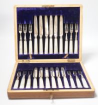 An Edwardian cased set of twelve pairs of silver and mother of pearl handled dessert eaters,