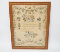 A framed sampler by Charlotte Betts, dated 1831, embroidered with a central religious verse,